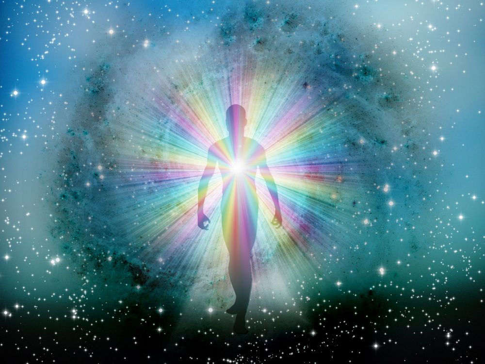 an illustration of the energy body with a rainbow of colors emanating from the heart center